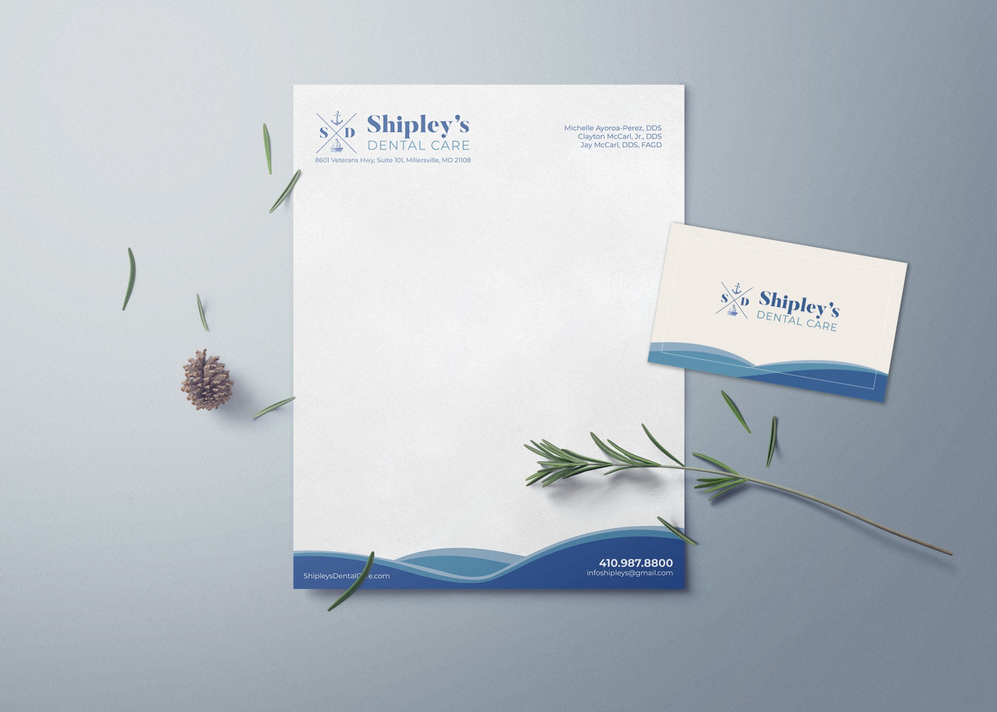 Dentist branding example: Shipley's Dental Care letterhead and business card with anchor logo and blue wave design